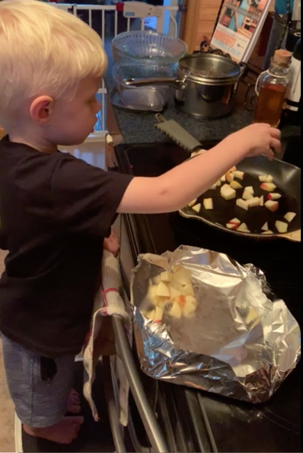 Toddler helping cook with cast iron