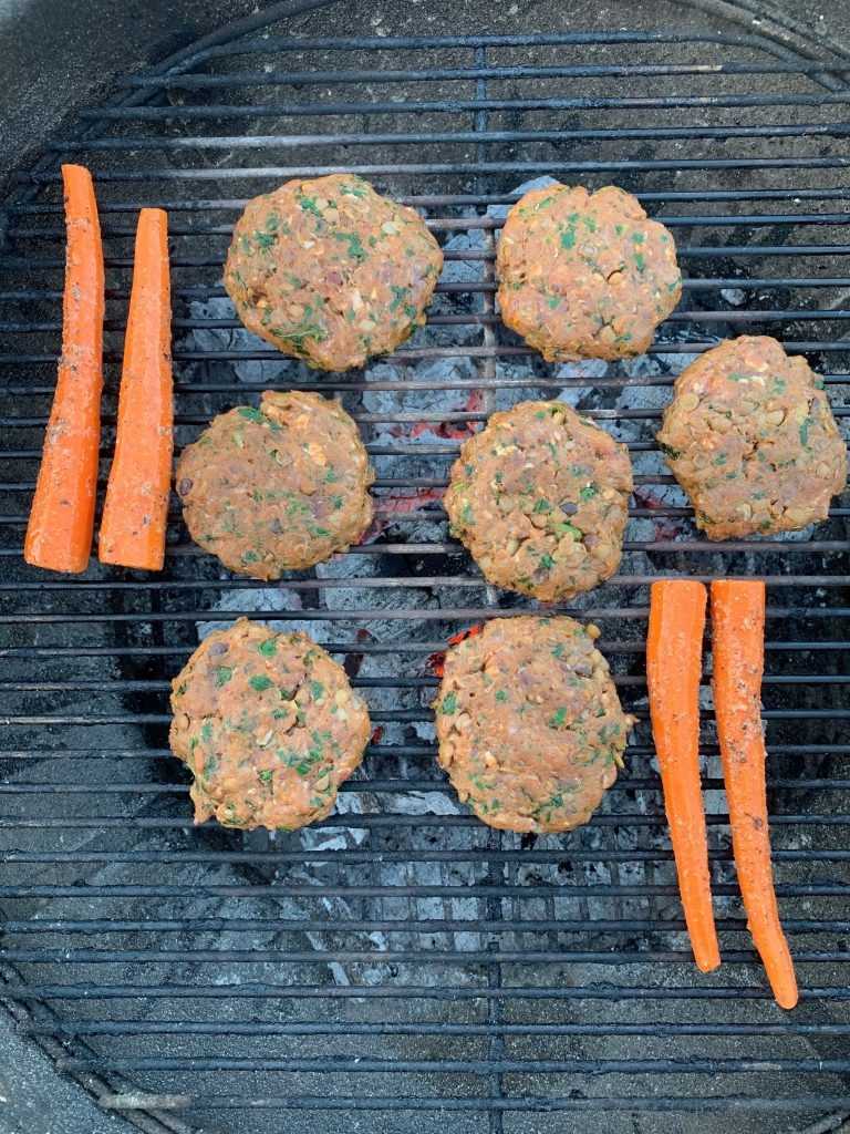 Carrots and burgers on grill